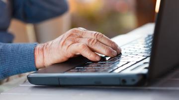 Closeup of an old man using the modern technology.